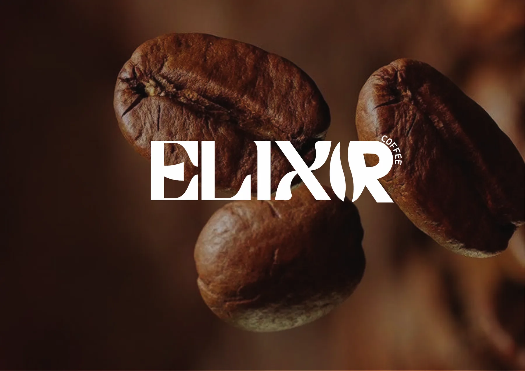 White Elixir wordmark over a macro photograph of roasted coffee beans
