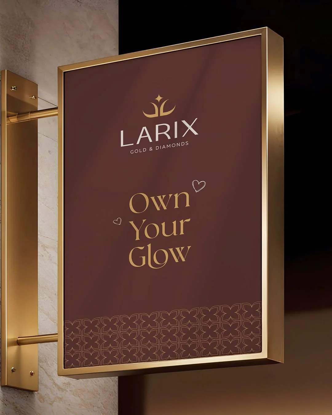 Gold-framed Larix signage reading “Own Your Glow”