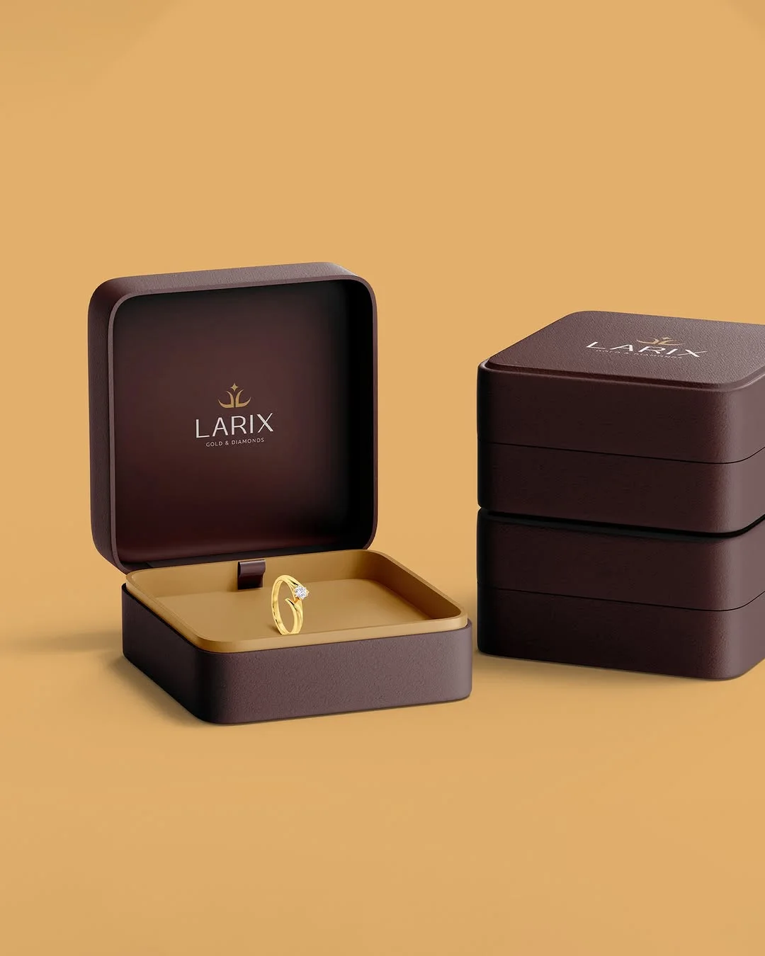 Plum and gold Larix ring boxes with a diamond ring