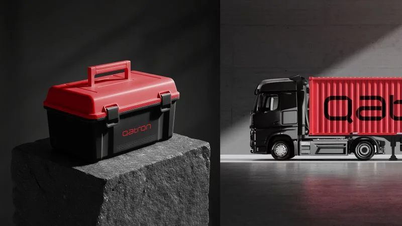 Red Qatron toolbox on stone beside a branded truck
