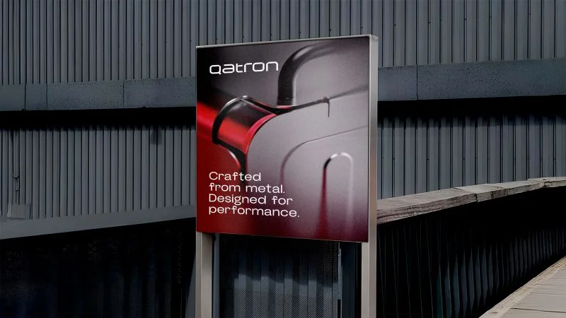 Qatron billboard reading Crafted from metal, designed for performance