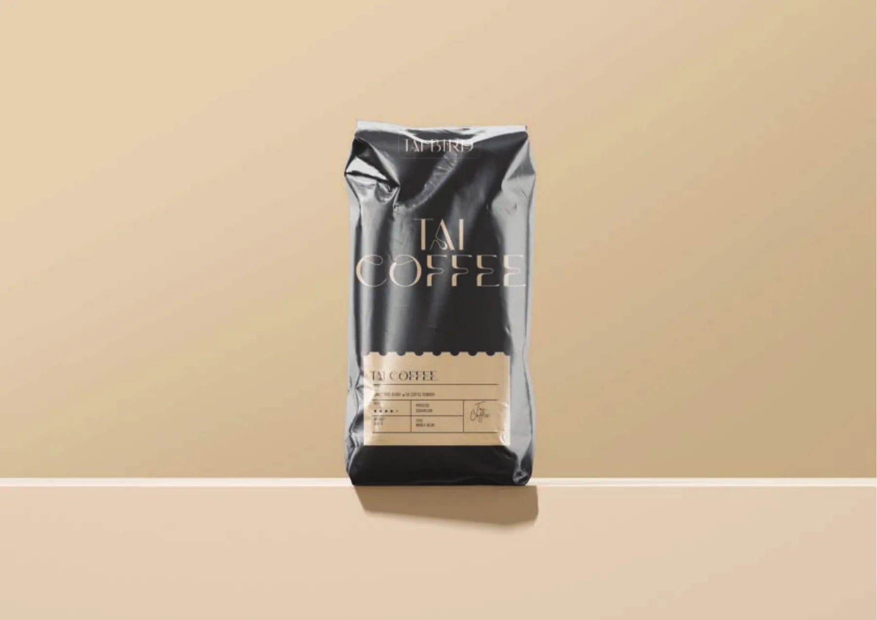 Black glossy Tai Coffee bag with a kraft specification label