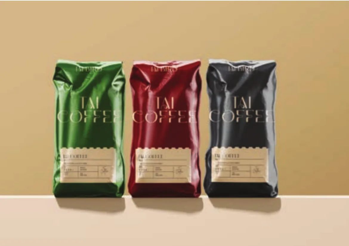 Green, crimson and black Tai Coffee bags in a row