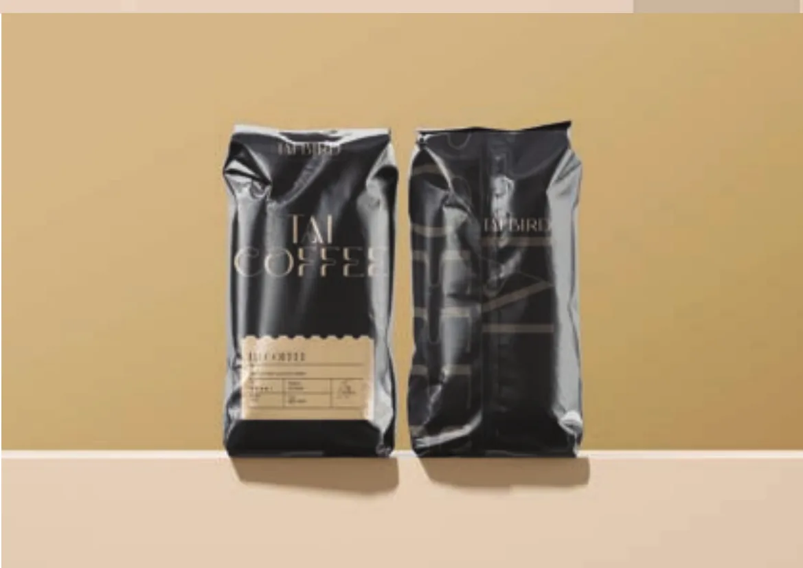 Two black Tai Coffee bags, front and back