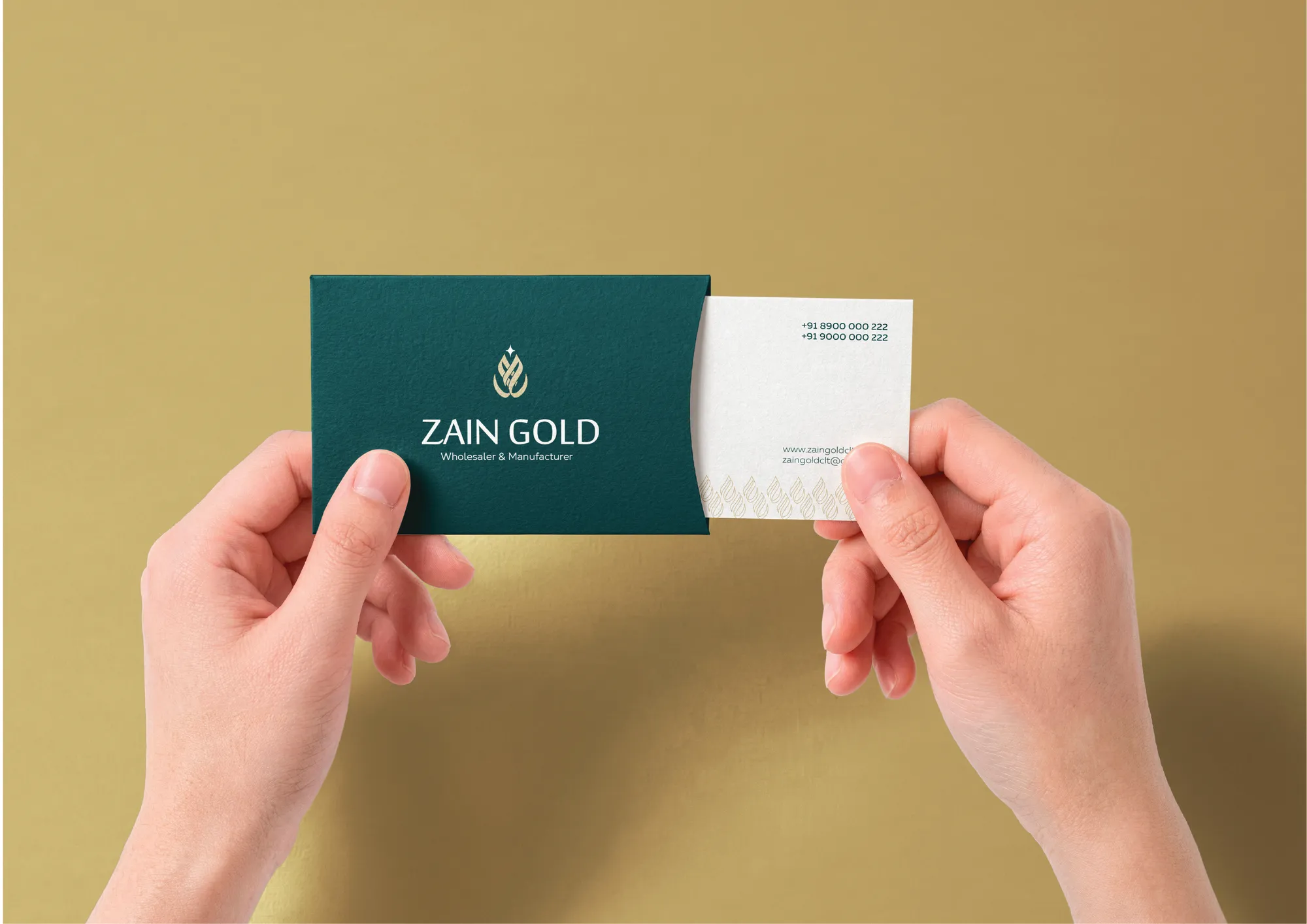 Zain Gold business cards held in hands